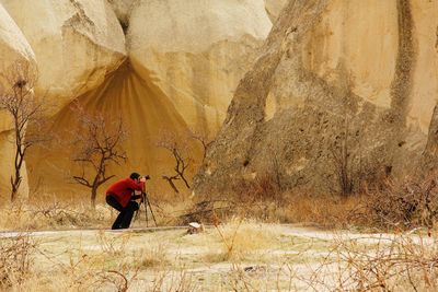 Side view of man walking on rock