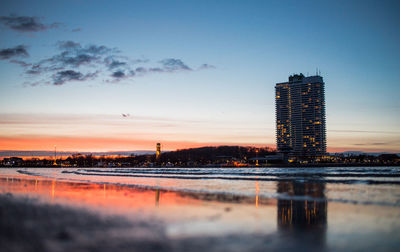 View of illuminated cityscape at sunset