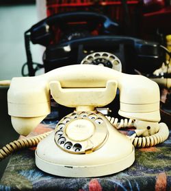 Close-up of old telephone booth on table