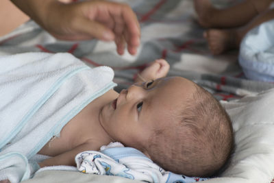 Cute baby lying on bed