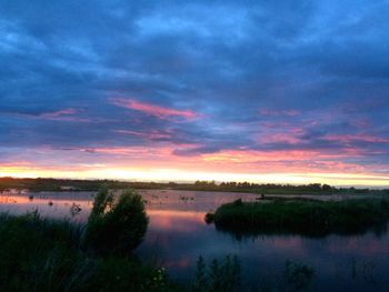 Scenic view of lake against sky during sunset