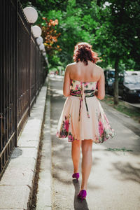 Rear view of young woman walking outdoors