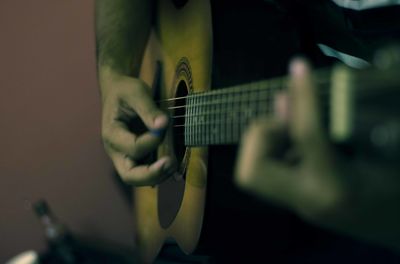 Close-up of man playing guitar