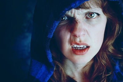 Close-up portrait of injured woman wearing blue hooded shirt