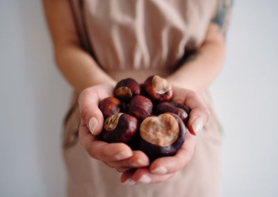 Midsection of woman holding chestnuts