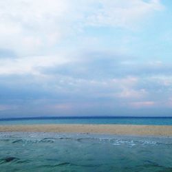 Scenic view of sea against cloudy sky