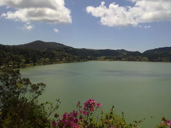 Scenic view of lake against cloudy sky