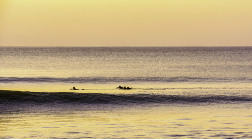 Scenic view of sea against clear sky during sunset
