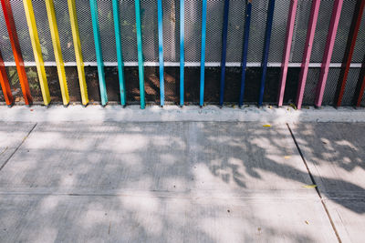 Shadow of person on footpath against building