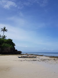 View of beach against cloudy sky