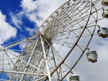 Low angle view of ferris wheel against sky