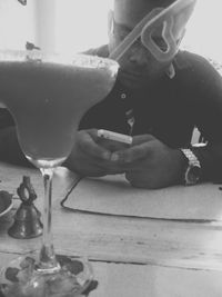 Portrait of young woman sitting on wall