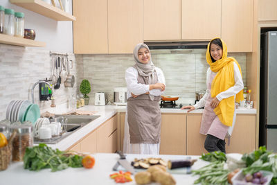 Woman standing by food at home