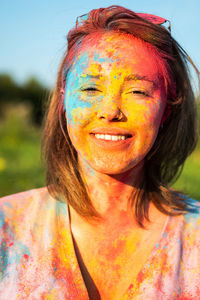 Woman covered holi powder in park. holi colours festival.