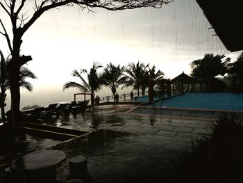 Swimming pool by sea against sky