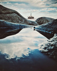 View of bridge over river against cloudy sky