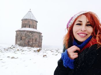 Portrait of smiling woman in snow