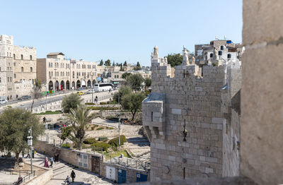 Buildings in city against clear sky