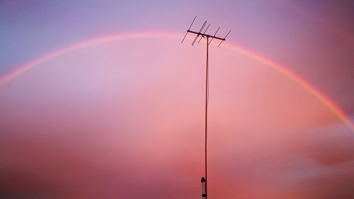 Low angle view of rainbow against sky during sunset