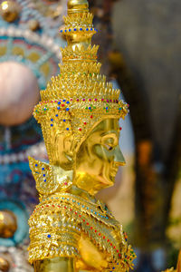 Close-up of buddha statue against building