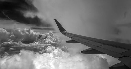 Airplane flying over cloudscape against sky