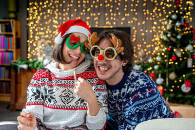 Young couple of lovers celebrating on christmas holy night - concept of christmas atmosphere