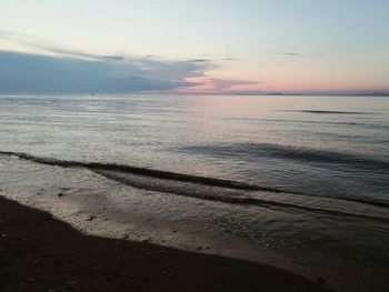 Scenic view of beach against sky during sunset