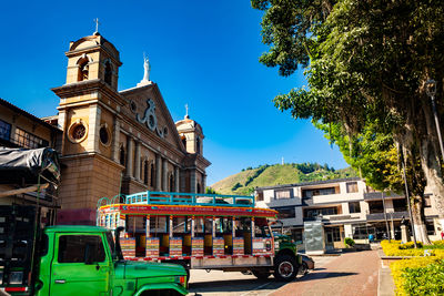 Colorful traditional bus from colombia called chiva at the central square of the town of pacora