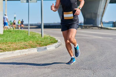 Full length of man running on road