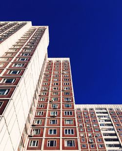 Low angle view of buildings against clear blue sky