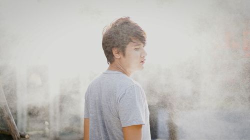 Man standing against wall