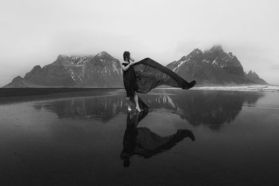 Glamorous woman on windy reynisfjara beach monochrome scenic photography