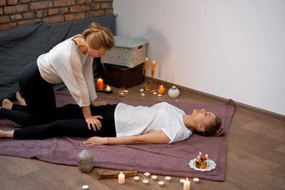 Rear view of people lying on table