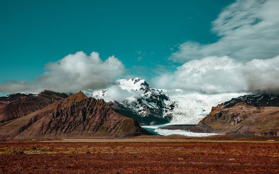 Landscape and mountains against sky