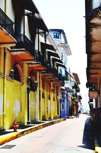 Street amidst buildings against sky in city