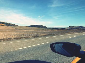 Close-up of car on road against sky