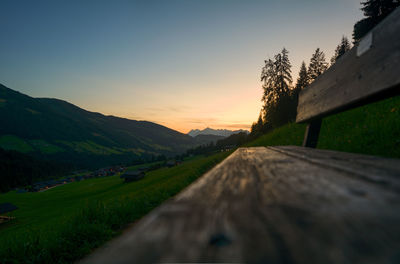 Scenic view of agricultural field against sky during sunset