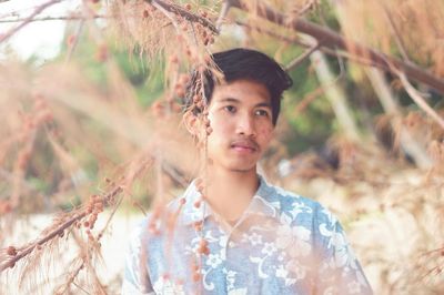 Portrait of young man standing outdoors