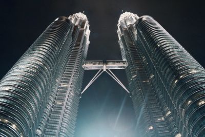 Low angle view of illuminated building against sky at night