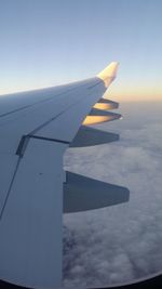 Close-up of airplane wing against sky