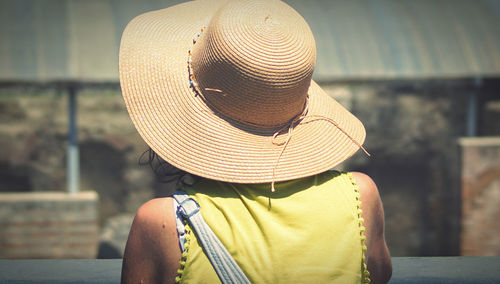Rear view of woman wearing hat outdoors