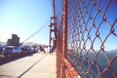 Close-up of chainlink fence against blue sky