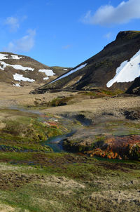 Flowing stream fed by a bubbling hot spring in rural iceland.