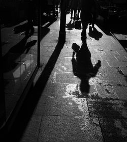 Low section of man walking on street