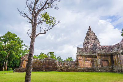 View of old temple against cloudy sky