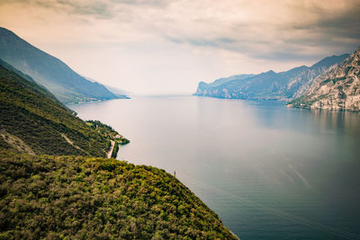 Scenic view of lake by mountains against sky