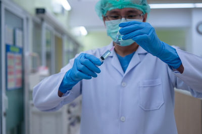 Portrait of young man holding umbrella