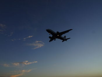 Low angle view of airplane flying in sky