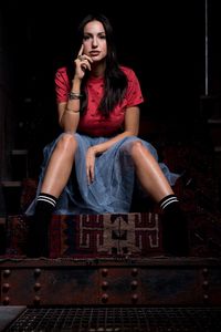 Portrait of beautiful woman sitting on wooden steps