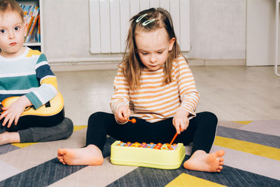 Child at home learning to play the xylophone. leisure and education at home